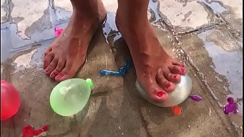 Foot fetish crushing water balloons with heels