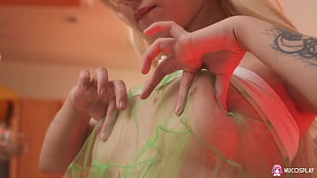 Blonde ketty small with a shaved pussy plays with a purple toy stimulating her pussy on the armchair