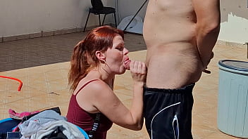 Redhead fucked in the backyard while hanging clothes on the clothesline