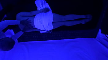 Horny naked slut gets massage under black light