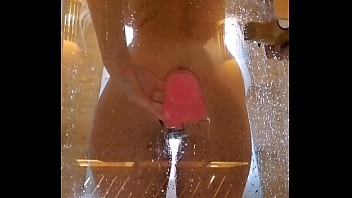 Girl with an appetizing ass is having fun in the shower with a pink dick