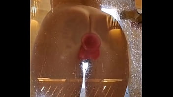Girl with an appetizing ass is having fun in the shower with a pink dick