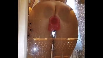 Girl with an appetizing ass is having fun in the shower with a pink dick