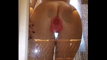 Girl with an appetizing ass is having fun in the shower with a pink dick
