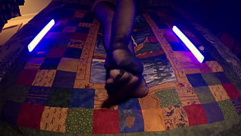 Sensual perfect feet peek through fishnet pantyhose