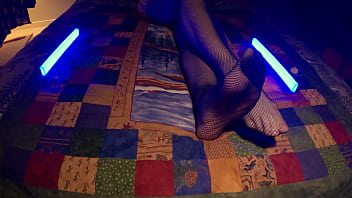 Sensual perfect feet peek through fishnet pantyhose