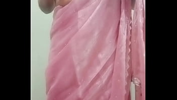 Indian Gay Crossdresser Gaurisissy Pressing And Playing With Her Big Boobs Looking In Pink Saree Looking Like A Housewife thumbnail