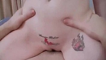 Tattooed brunette rides cock