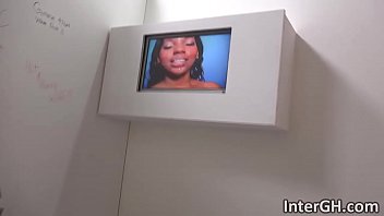 Adrian talks on phone while pleasing rod in glory hole