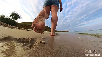 Barefoot walks over the summer seashore Barefoot walks over the summer seashore