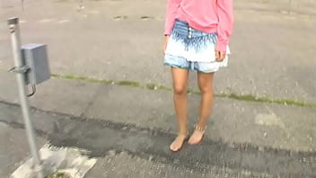 Bimba siting barefoot in her volkswagen car revving the engine