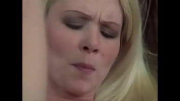 Blonde whore fingers her twat and gets off laying in sofa