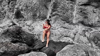 A stepmom practices sucking on a candy on the beach then tests her skills on her stepson's dick