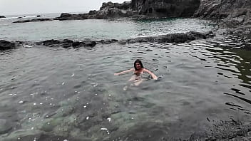 A stepmom practices sucking on a candy on the beach then tests her skills on her stepson's dick