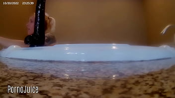 Petite blonde plays with huge bbc toy in the bath
