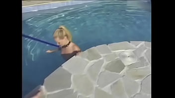 Young blonde masturbates on an inflatable mattress in the pool