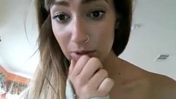 Brownhaired girl curled up on chair bating