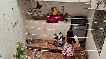 The neighbor is watched washing clothes by her neighbor