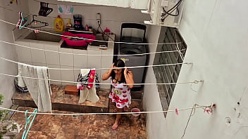 The neighbor is watched washing clothes by her neighbor