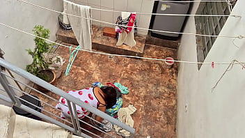The neighbor is watched washing clothes by her neighbor
