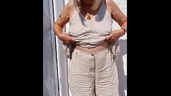 Flopping her tits out outdoors