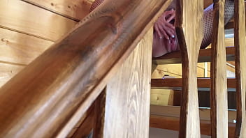 Sexy girl in mask and mesh suit without panties caresses her excited pussy and masturbates her to a real female orgasm on the stairs