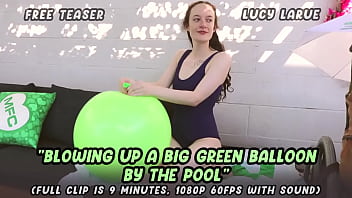 Blowing up a big green balloon by the pool