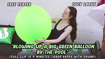 Blowing up a big green balloon by the pool