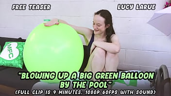 Blowing up a big green balloon by the pool