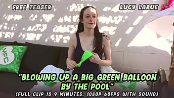Blowing up a big green balloon by the pool