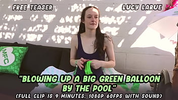 Blowing up a big green balloon by the pool Blowing up a big green balloon by the pool
