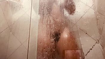 Girl being filmed while taking a shower showing off her hairy pussy