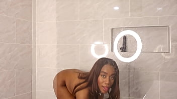 Ebony slut in a swimsuit bathes in milk and masturbates her wet pussy