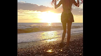 Sunset girl at the sea beach