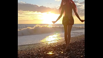 Sunset girl at the sea beach