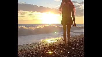 Sunset girl at the sea beach