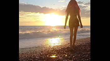 Sunset girl at the sea beach