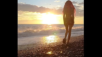 Sunset girl at the sea beach