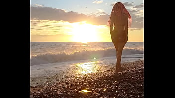Sunset girl at the sea beach