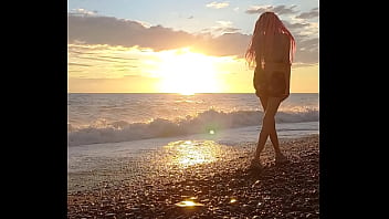 Sunset girl at the sea beach