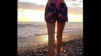 Sunset girl at the sea beach