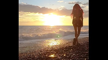 Sunset girl at the sea beach