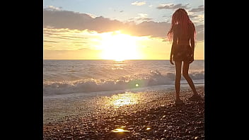 Sunset girl at the sea beach