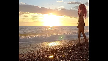 Sunset girl at the sea beach