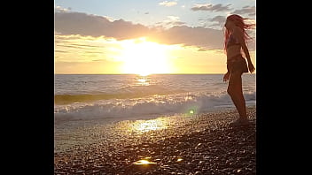 Sunset girl at the sea beach