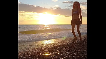 Sunset girl at the sea beach