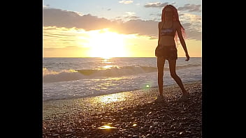 Sunset girl at the sea beach
