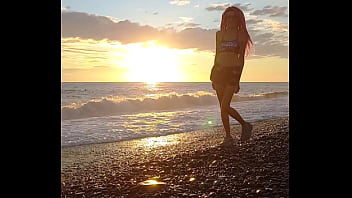 Sunset girl at the sea beach