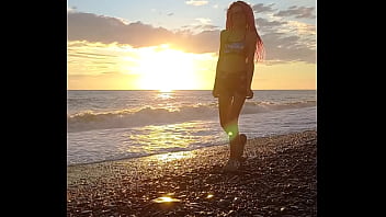 Sunset girl at the sea beach