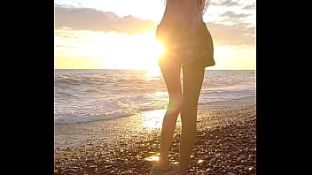 Sunset girl at the sea beach